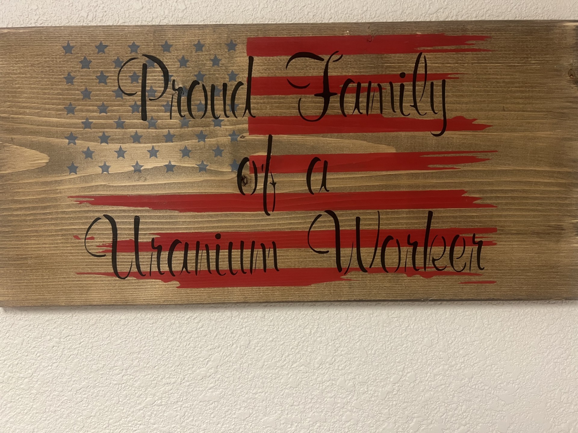 Proud family of a uranium worker, rustic wood sign